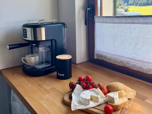 a kitchen counter with a blender and a plate of food at Domki nad rzeką- Smerekowiec in Smerekowiec