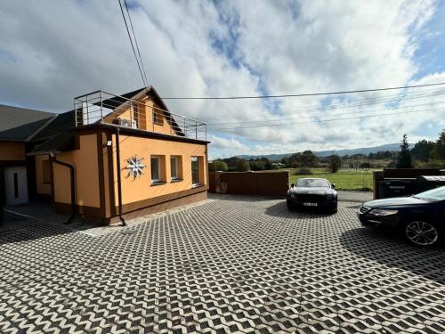 a house with a car parked in front of it at Apartments Gato Karlovy Vary Jenišov in Karlovy Vary