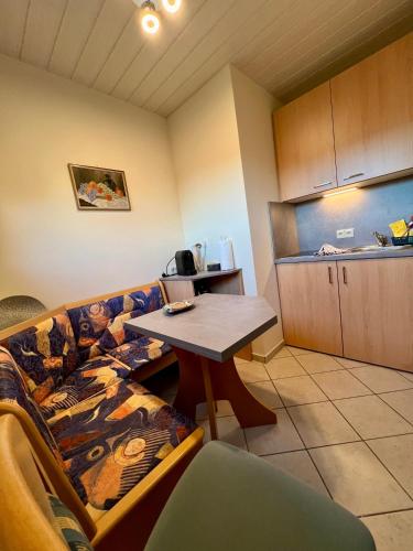 a living room with a couch and a table at Gästehaus Wallner in Presseggen