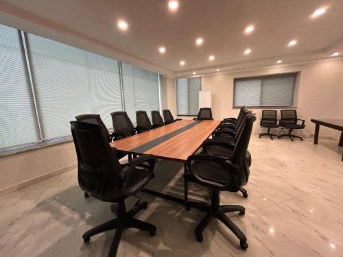 a large conference room with a long table and chairs at Hotel One The Mall, Lahore in Lahore