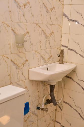 a bathroom with a sink and a toilet at Builders Homes and Apartments in Ibadan