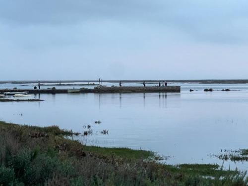a large body of water with a pier in it at Casa Saudade luxury rooms in Faro
