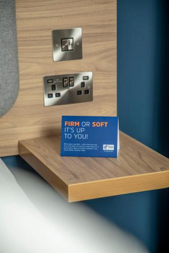 a sign on a shelf with a box on it at Holiday Inn Express Royal Docks by IHG in London
