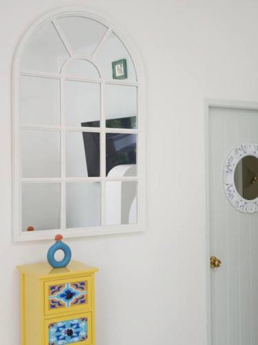 a bathroom with a window and a yellow dresser at Lamp U House Amphawa in Amphawa