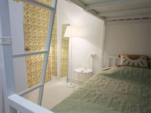 a small bedroom with a bed and a window at Lamp U House Amphawa in Amphawa