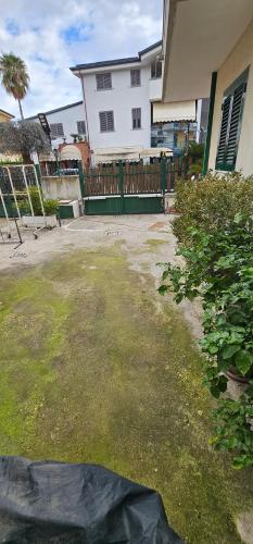 a yard in front of a house with a fence at B&B Gianni in Capodrise