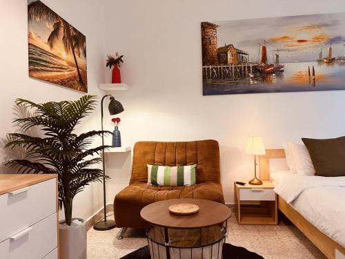 a living room with a bed and a chair and a table at ONE Guest Place Master Bedroom near the Beach in Abu Dhabi