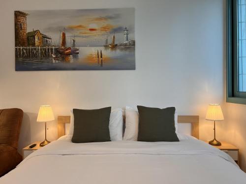 a bedroom with a bed and a painting on the wall at ONE Guest Place Master Bedroom near the Beach in Abu Dhabi