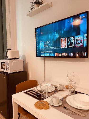 a dining room table with a tv on the wall at ONE Guest Place Master Bedroom near the Beach in Abu Dhabi