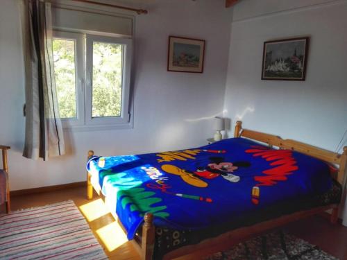 a bedroom with a bed with a colorful comforter at Lydia in Samos