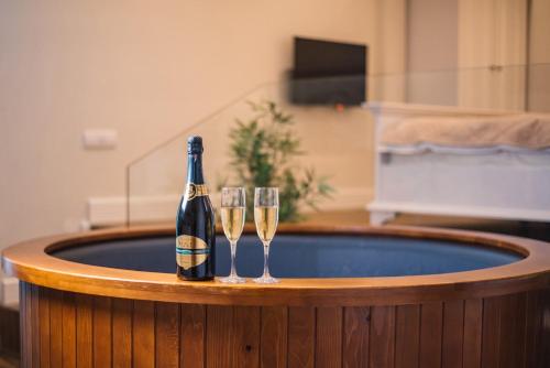 a bottle of champagne and two wine glasses at Padam Hotel & SPA in Ulcinj