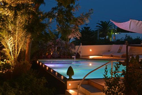 a swimming pool in a backyard at night at Il Gabbiano Relais in Stromboli in Stromboli