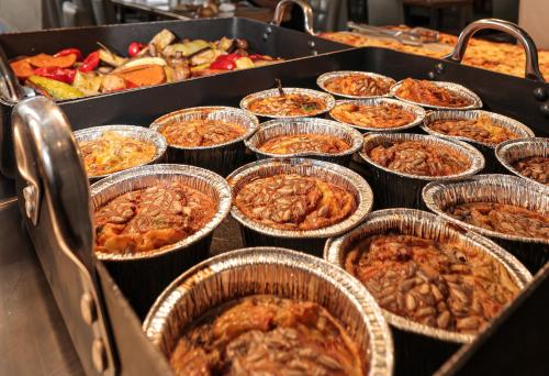 a buffet of different types of food in paper cups at G hotel in Eilat