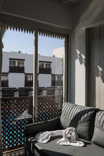 a living room with a couch and a large window at G hotel in Eilat