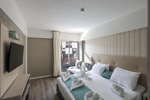 a hotel room with a bed and a television at G hotel in Eilat