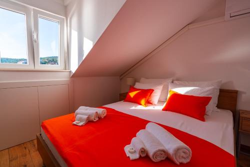 a attic bedroom with a bed with towels on it at Nerica Apartment in Zavalatica