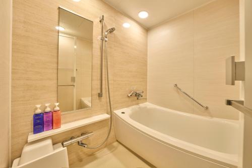 a bathroom with a tub and a toilet and a sink at Keisei Richmond Hotel Tokyo Kinshicho in Tokyo