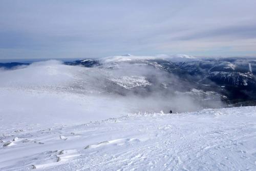 a person is skiing down a snow covered mountain at Hotel Hvezda in Pec pod Sněžkou