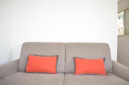 two orange pillows sitting on top of a couch at Sopramare Resort in Piano di Sorrento