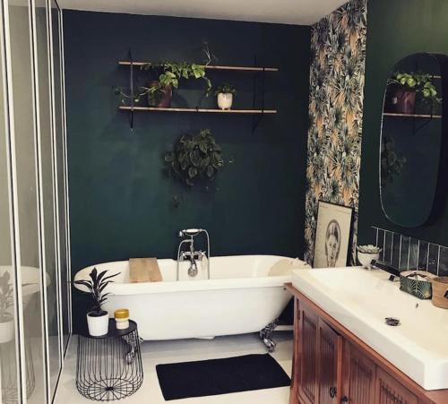 a bathroom with a white tub and two sinks at Jolie maison de ville au calme in Marcq-en-Baroeul