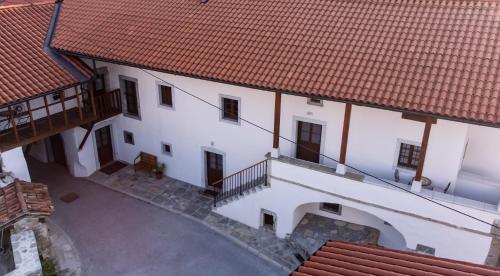 an overhead view of a white building with red roofs at Wellba Homestead Planina in Ajdovščina