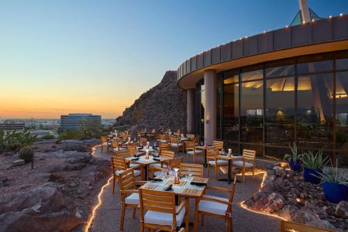 a restaurant with tables and chairs in front of a building at Phoenix Marriott Resort Tempe at The Buttes in Tempe
