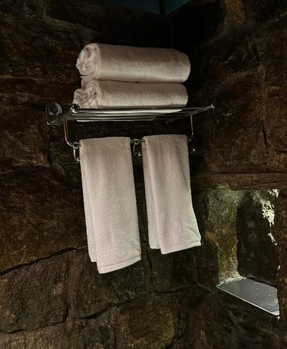 a towel rack with towels and a statue of a lion at Marmaram Heritage in Vagamon