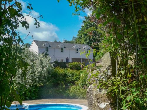 a house from the garden with a swimming pool at Buckstone House Coach House in Coleford