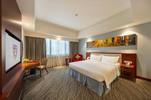 a hotel room with a large bed and a flat screen tv at Saigon Prince Hotel in Ho Chi Minh City