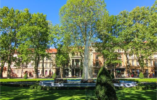 a building with a fountain in the middle of a park at Beautiful Home In Bedenica With Wifi in Bedenica