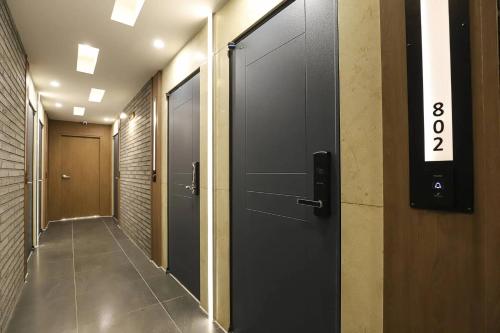 an elevator corridor with a door with the number eight at Rosy Hotel in Cheongju