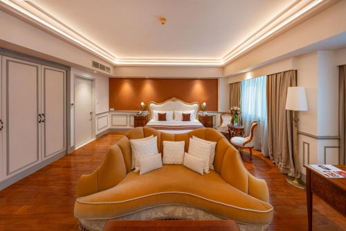 a hotel room with a bed and a couch at Saigon Prince Hotel in Ho Chi Minh City