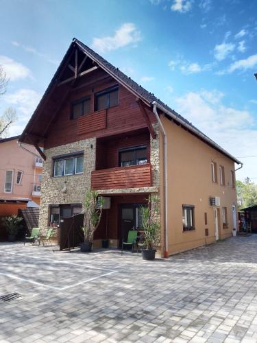 a house with a gambrel roof at New Beachapartman in Siófok