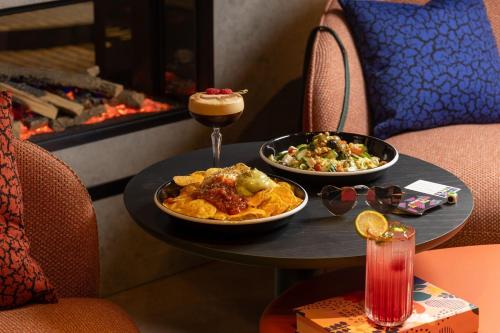 a table with two plates of food and a drink at Moxy Cork in Cork