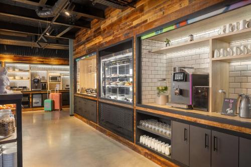 a kitchen with a counter with a lot of food at Moxy Cork in Cork