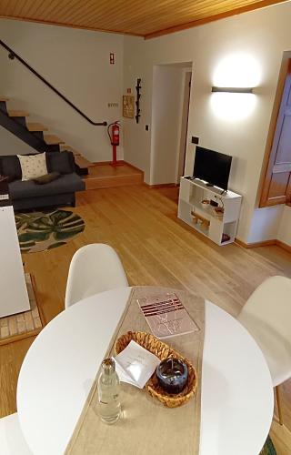 a living room with a table and chairs and a living room at Golden Mountain, Nature House in Manteigas