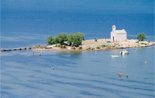 an island with a church in the middle of the water at Cozy Home In Posedarje With Wifi in Posedarje