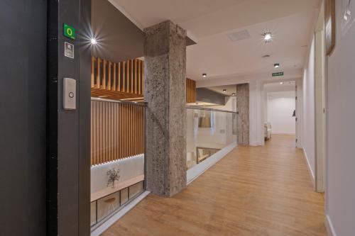 a hallway of an office building with columns and a staircase at Uma Suites Ondarreta in Donostia-San Sebastián