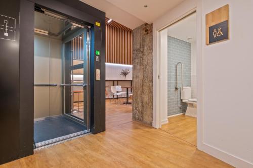 a hallway with a glass door leading to a dining room at Uma Suites Ondarreta in Donostia-San Sebastián