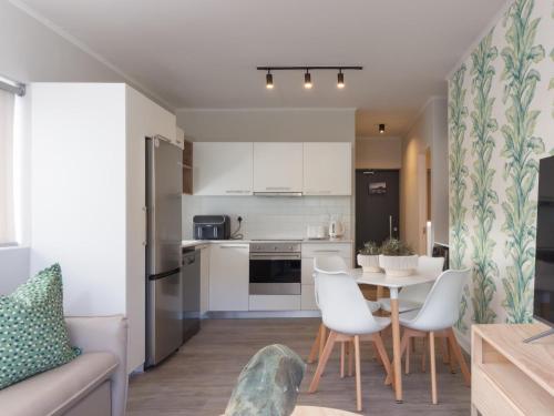 a kitchen and living room with a table and chairs at 201 & 210 Mossel Cove in Mossel Bay