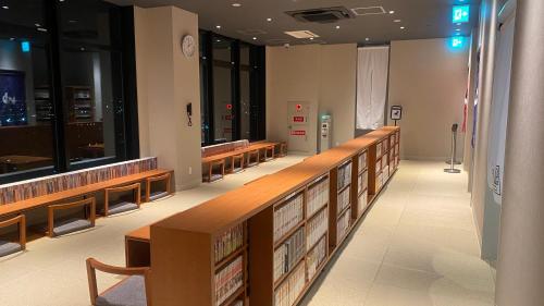 a row of wooden benches in a synagogue at REF Kansai Airport by VESSEL HOTELS in Izumi-Sano