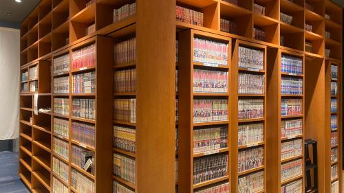 a book shelf filled with lots of books at REF Kansai Airport by VESSEL HOTELS in Izumi-Sano