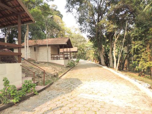 a cobblestone road in front of a house at Pousada Juriti - Eco Hotel in São Roque