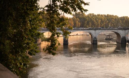 a bridge over a river with a train on it at The First Musica - Preferred Hotels & Resorts in Rome
