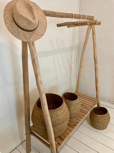 a straw hat on a wooden stand next to baskets at Gîte d'exception - Manoir de Sacquenay in Sacquenay