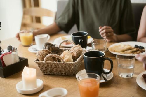 a table with a basket of pastries and a candle at Ölerhof in Haag am Hausruck