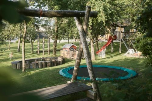 a playground in a park with a swing at Ölerhof in Haag am Hausruck
