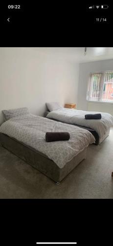 two beds sitting next to each other in a bedroom at 4 Bedroom Contractors House in Sheffield