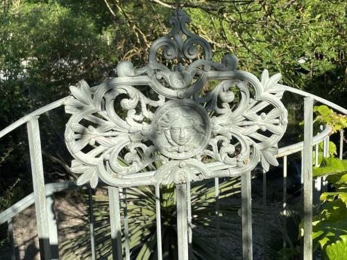 a metal gate with a head on it at Le Domaine de La Tuilerie - Gite de charme en bord de riviere avec piscine in Serviès-en-Val