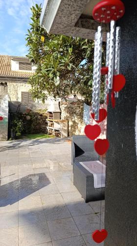 a bench with red hearts hanging from a wall at Orion Guesthouse Telhado in Fundão